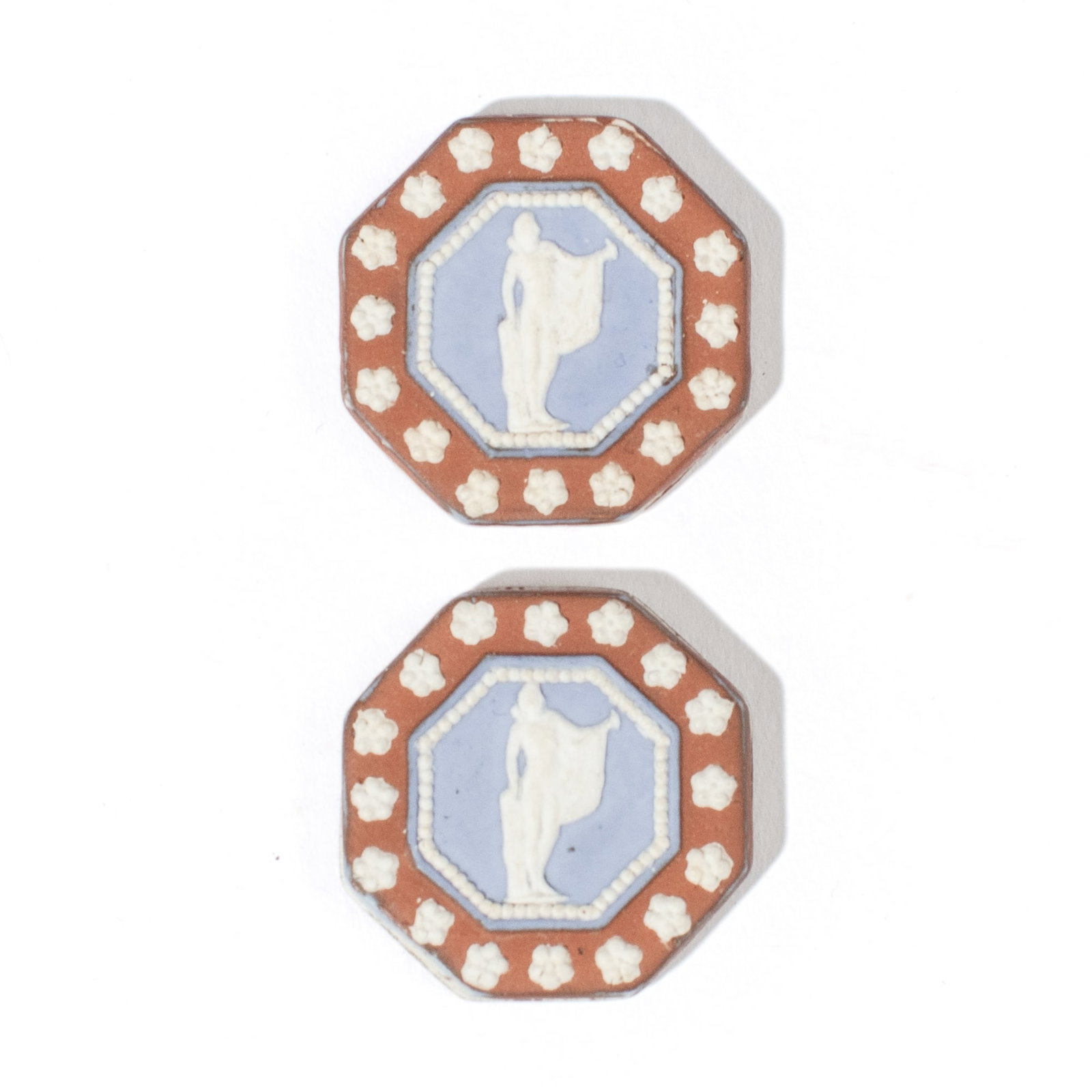 Two Wedgwood Tricolor Jasper Double-Sided Cameos: Two late 18th century Wedgwood tricolor jasperware double-sided cameos, each of octagonal form with maidens and flowerhead border in blue, white and chocolate brown. Both in very good condition. Each 