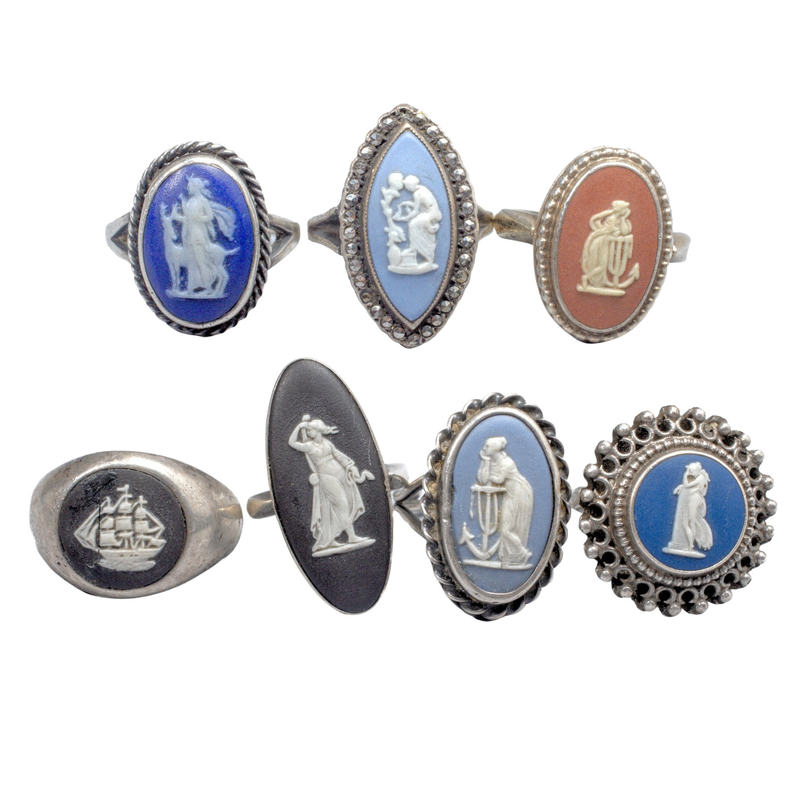 7 Wedgwood Jasperware & Sterling Silver Rings: Seven Wedgwood rings with various jasperware cameos, including "Anchor of Hope" and sailing ship in white over blue, black and terracotta. All with stamped marks to band. Most in very good condition; 