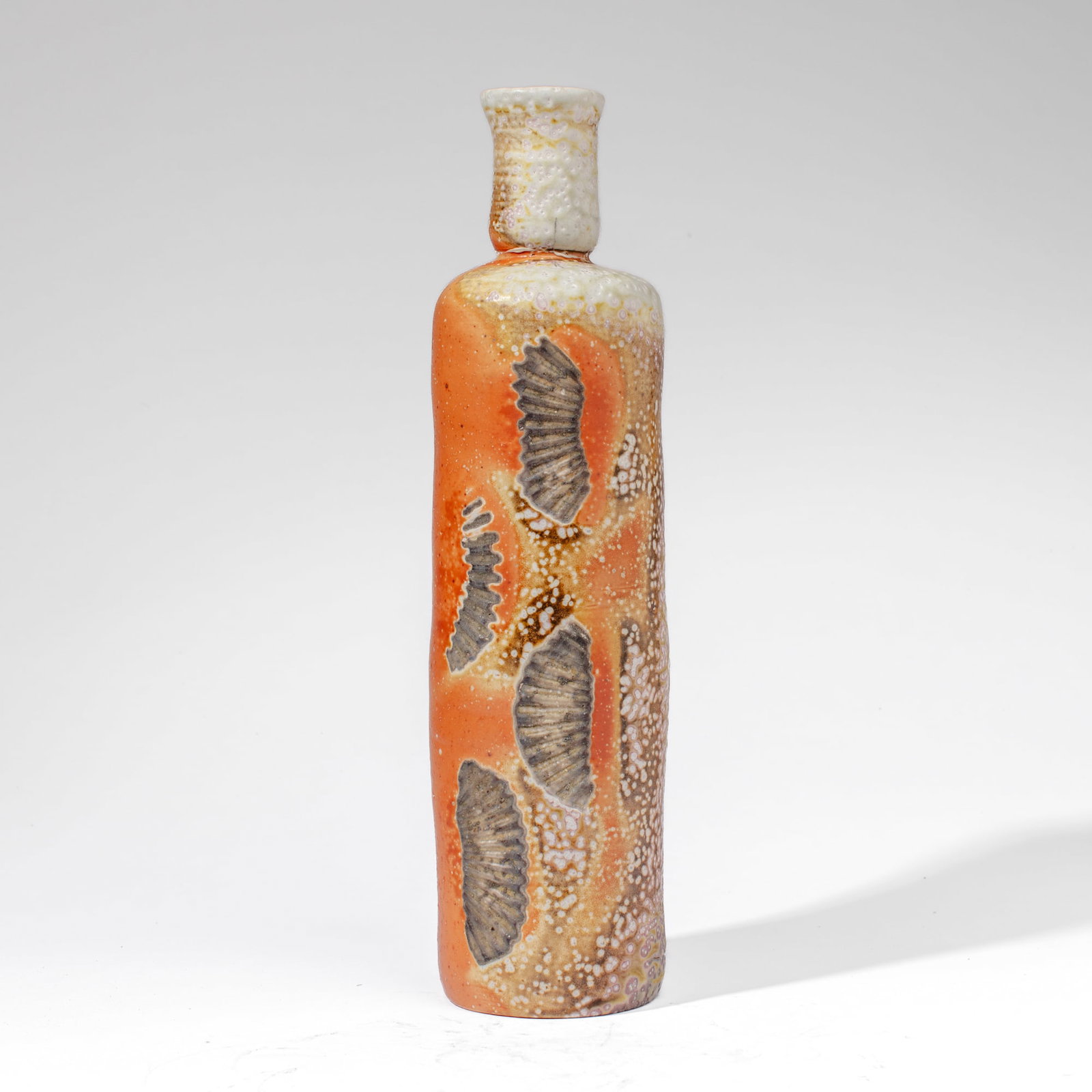 Carolanne Currier "Four Shells" Bottle Vase: Carolanne Currier (Pennsylvania) "Four Shells" Soda Fired Stoneware Bottle Vase. Marked on base with artist monogram. Measures 16x5". Collection of Mike Peck, Seattle WA. Excellent condition.