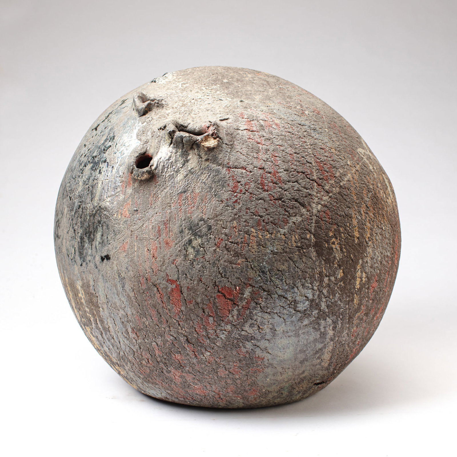 Large Wood Fired Spherical Ceramic Sculpture: Large Wood Fired Spherical Ceramic Sculpture. Signed on base; appears to read Rutuson; artist unknow. Artwork has 3 hand made finger holes as well as various small holes and crevices. Dramatic and