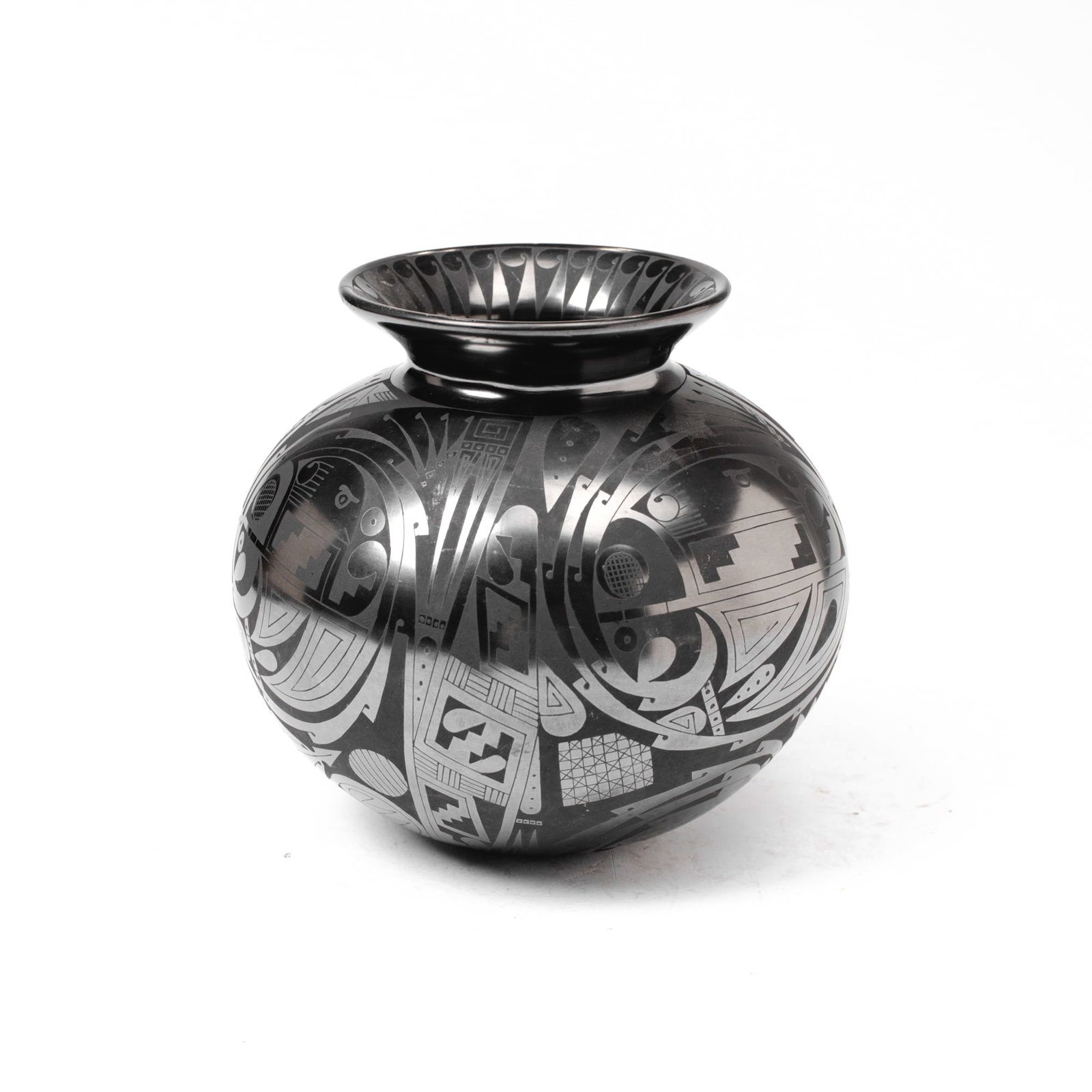 Mata Ortiz Blackware Pottery Jar by Macario Ortiz: Mata Ortiz blackware pottery olla jar by Macario Ortiz with geometricized fishes within roundels between geometric and sun motifs below. Signed and dated 1992. In very good condition. 6.5" H x 7" D at