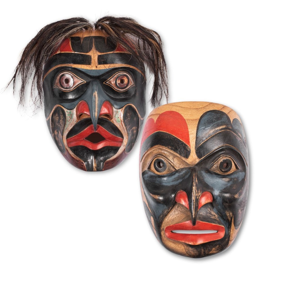 Two Northwest Coast Style Bukwas Masks: Two Northwest Coast style Bukwas masks in hand carved mahogany type wood with polychrome surfaces. The Bukwus or Wild Man of the Woods is a supernatural creature from the Kwakwaka?wakw Nation. No appa