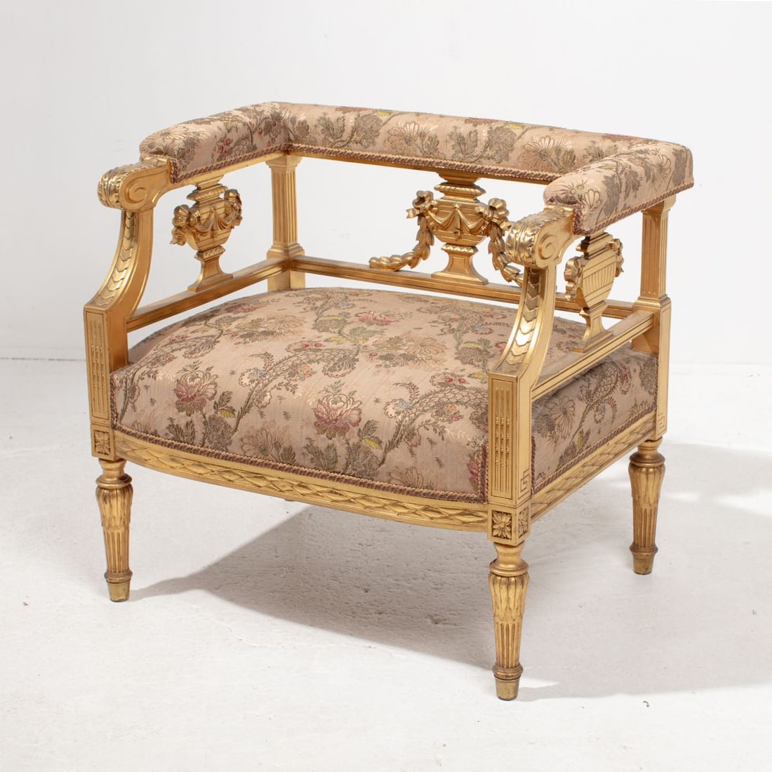 Louis XVI Style Gilt Boudoir Chair: Early 20th century French Louis XVI style boudoir chair. Gilt and gresso carved wood frame with urn slats to sides and back. Floral tapestry upholstery over horse hair and coil spring seat; upholstere