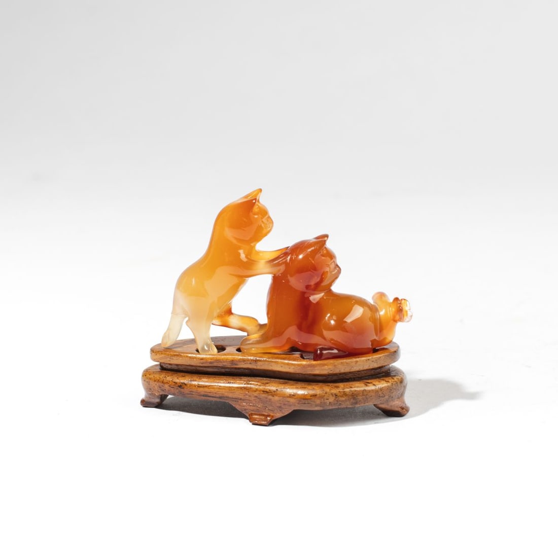 Chinese Carved Carnelian Stone Cats & Butterfly: Chinese carved carnelian depiction of two cats with butterfly at tail of one, modeled in the round with incised details. Includes custom-fitted rosewood stand. Loss to one tail and tail has been reglu