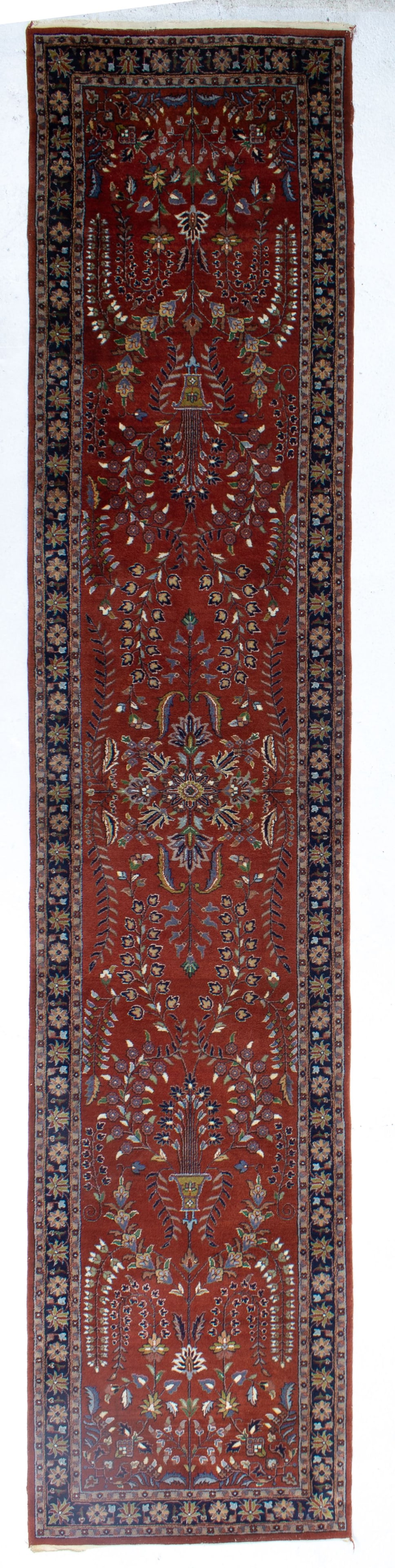 Hand Knotted Persian Runner Rug 13': Hand knotted wool on cotton. Brown field with center medallion and vases with floral tracery designs. Good condition. 2' 10" x 13' approx.