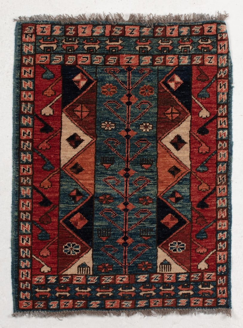Vintage Kazak Wool Scatter Rug: Vintage Kazak Wool Scatter Rug. High pile wool. Colorful small rug with central vine motif and geometric borders. Measures 34x25". Some wear to edge binding; overall good condition.