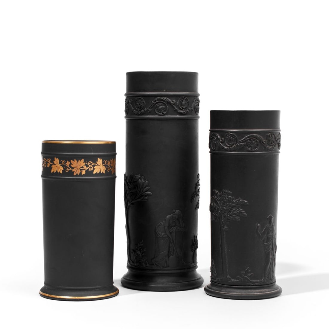Three Wedgwood Black Basalt Spill Vases: Three Wedgwood black basalt spill vases. (1): Early 20th century spill vase having two muses between laurel trees below scrolling anthemion border at shoulder. Impressed "WEDGWOOD" and "MADE IN ENGLAN