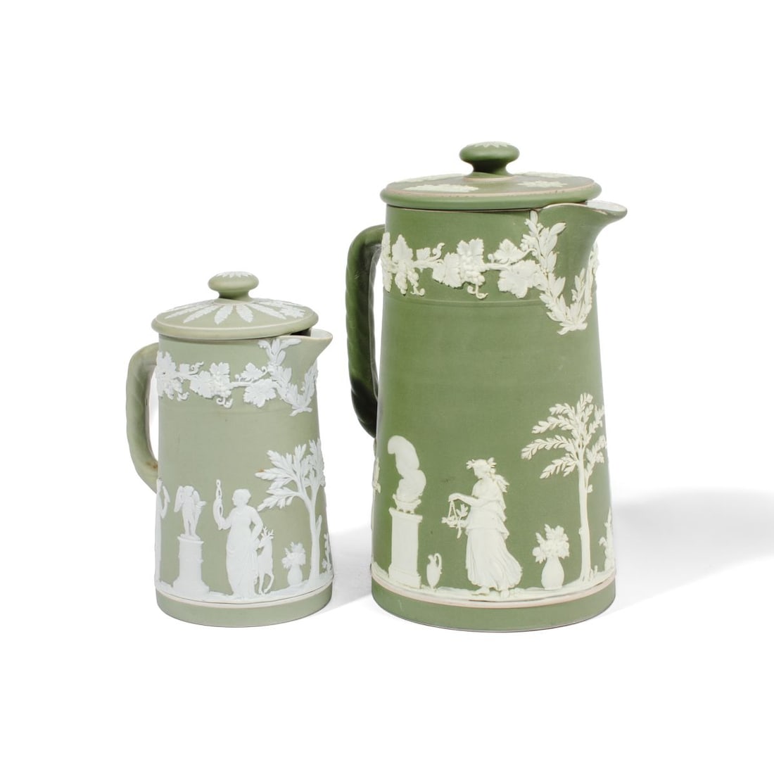 Two Large Wedgwood Green Dip Jasper Pitchers: Two large early 20th century Wedgwood green dip jasperware pitchers. (1): Classical maidens offering sacrifice below grape pattern. Impressed "WEDGWOOD" and "ENGLAND" marks to underside. 8" H x 5.5" h