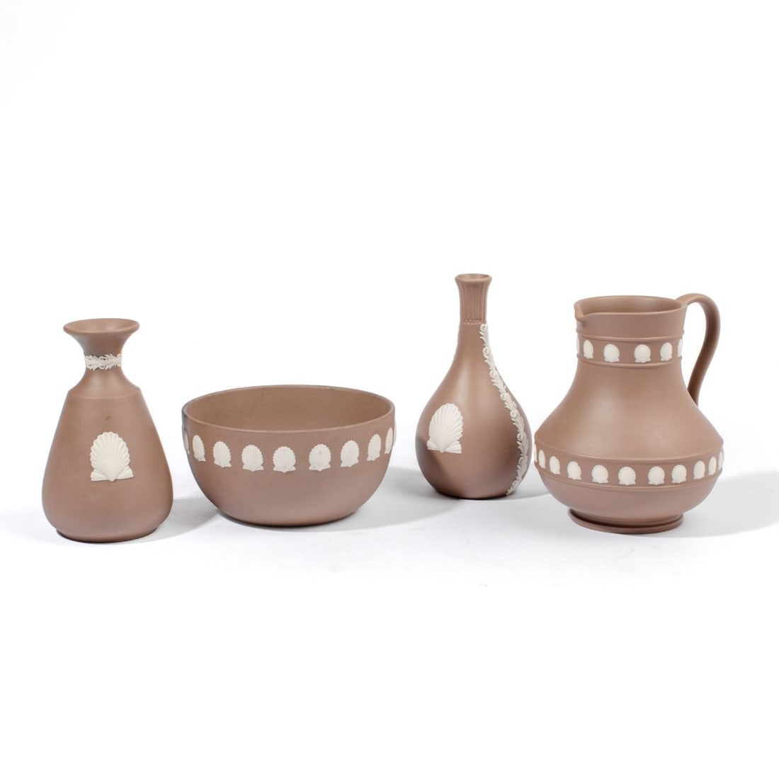 Wedgwood Brown Jasper Shell / Vases / Bowl: Four 20th century Wedgwood brown jasperware articles, each having shell pattern in white. Includes two bud vases, bowl and pitcher. Each has impressed "WEDGWOOD MADE IN ENGLAND" marks to underside. Al