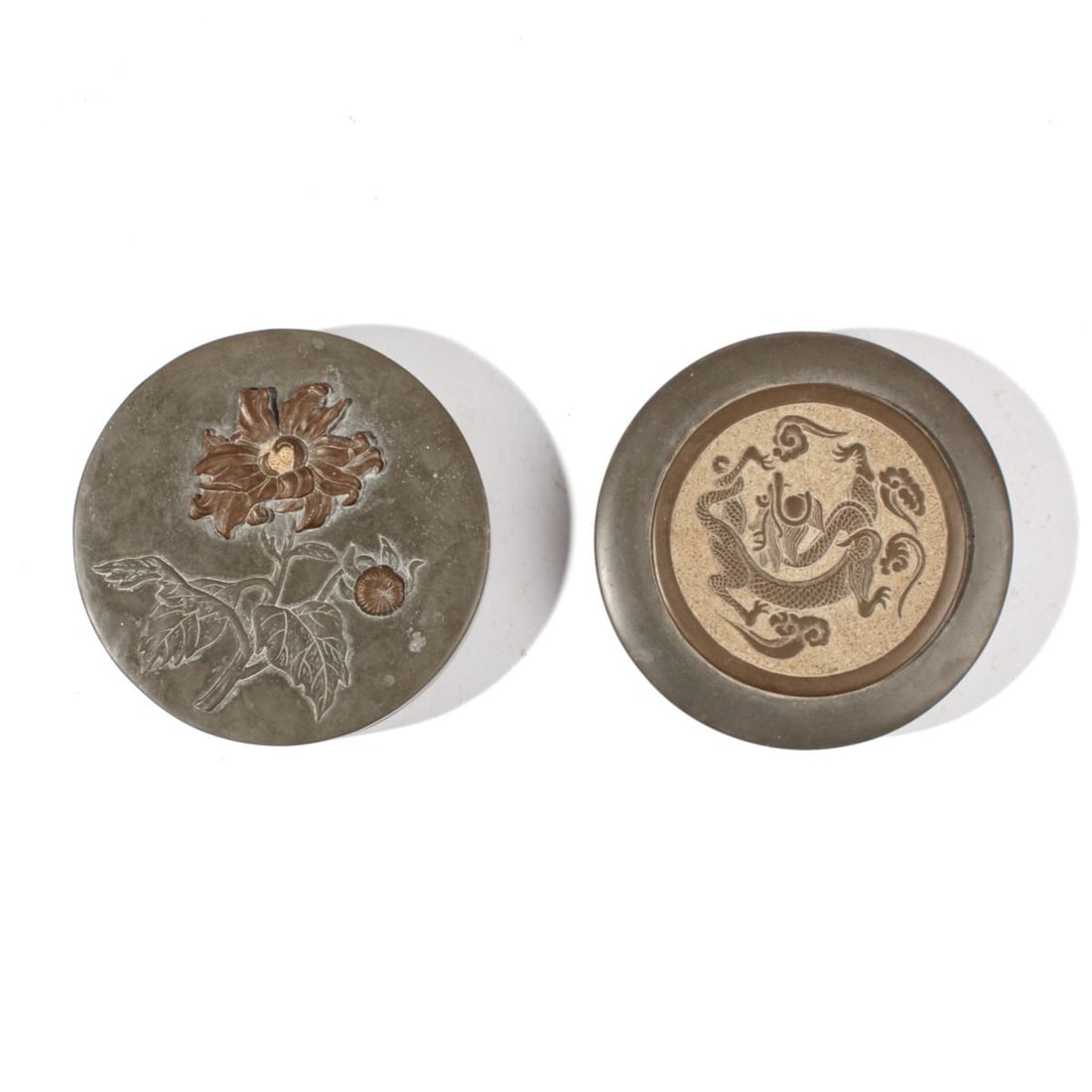 Two Asian Inkstones / Dragon & Chrysanthemum: Two carved inkstones with covers. (1): Dragon among clouds. Some nibbles to edge; in very good condition. 4" D. (2): Chrysanthemum flowers in colored stone. Very slight loss to lower edge; in very goo