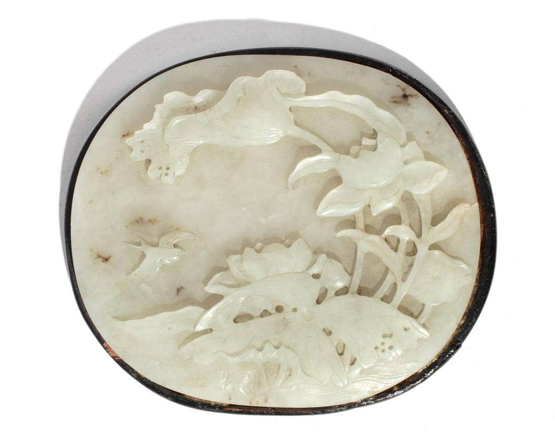 Chinese Song / Ming White Jade Oval Plaque: Song to Ming Dynasty Chinese white jade oval plaque. Finely carved and well detailed low relief carving depicting lotus flowers and flying bird. Mounted to rosewood. good condition. 3.5" x 4" approx.