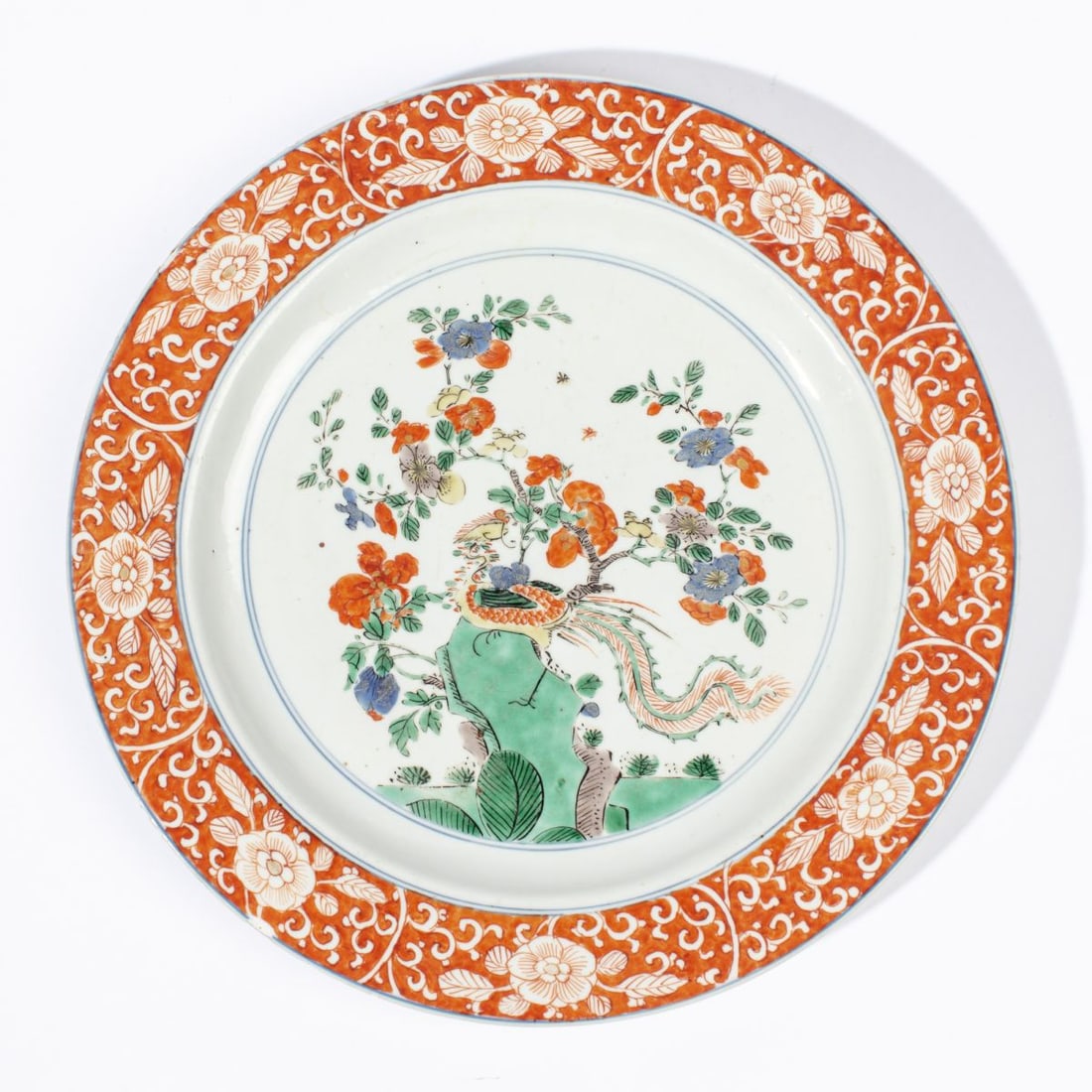 Chinese Kangxi Famille Verte Phoenix Plate: Kangxi period (1622-1722) Chinese Famille Verte decorated plate depicting a phoenix bird on top of a rock by a flowering tree. Rim with numerous small chips, nicks, nibbles, etc. 10.5" dia. approx.