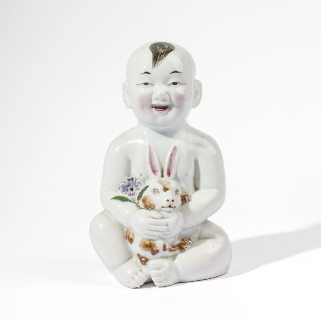 Chinese Porcelain Boy & Rabbit Figure: Early 20th century Chinese figure of a boy holding a rabbit. White glaze with color details. Good condition. 10.75' H approx.