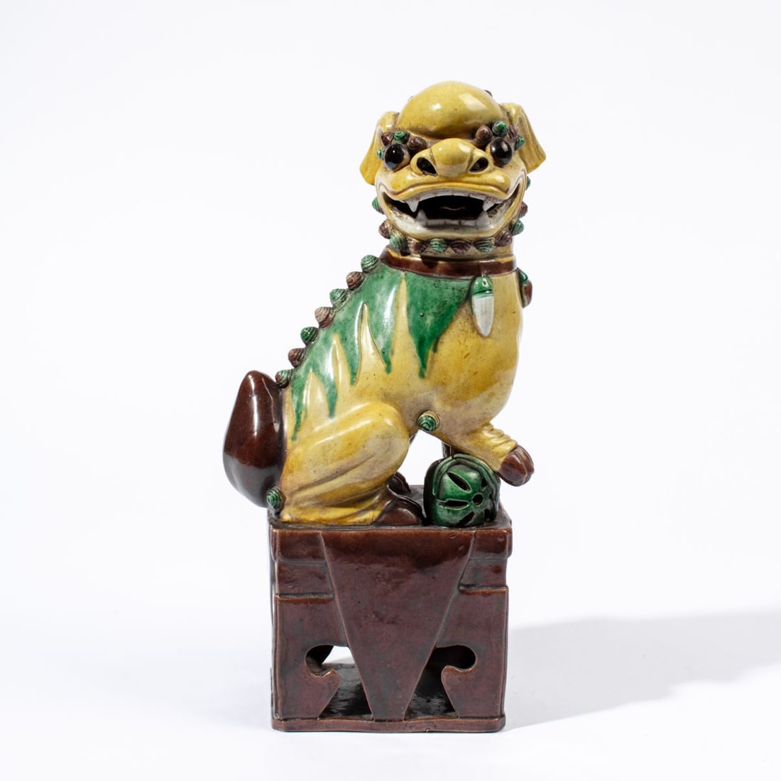 Chinese Qing Biscuit Glaze Foo Dog 13.75": Late Qing dynasty Chinese large Foo dog figure glazed in yellow, green, and aubergine. Open mouth with tongue visible. Hand marked CHINA in black to bottom. Good condition. 13.75" H approx.