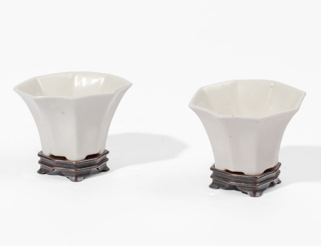 Pair 18th C. Chinese Dehua Octogonal Cups: Pair 18th century Chinese Dehua (Blanc de Chine) octogonal footed cups. Each with an old custom carved hardwood stand. A similar pair is in the collection of The Sunset Club, Seattle. Excellent condit