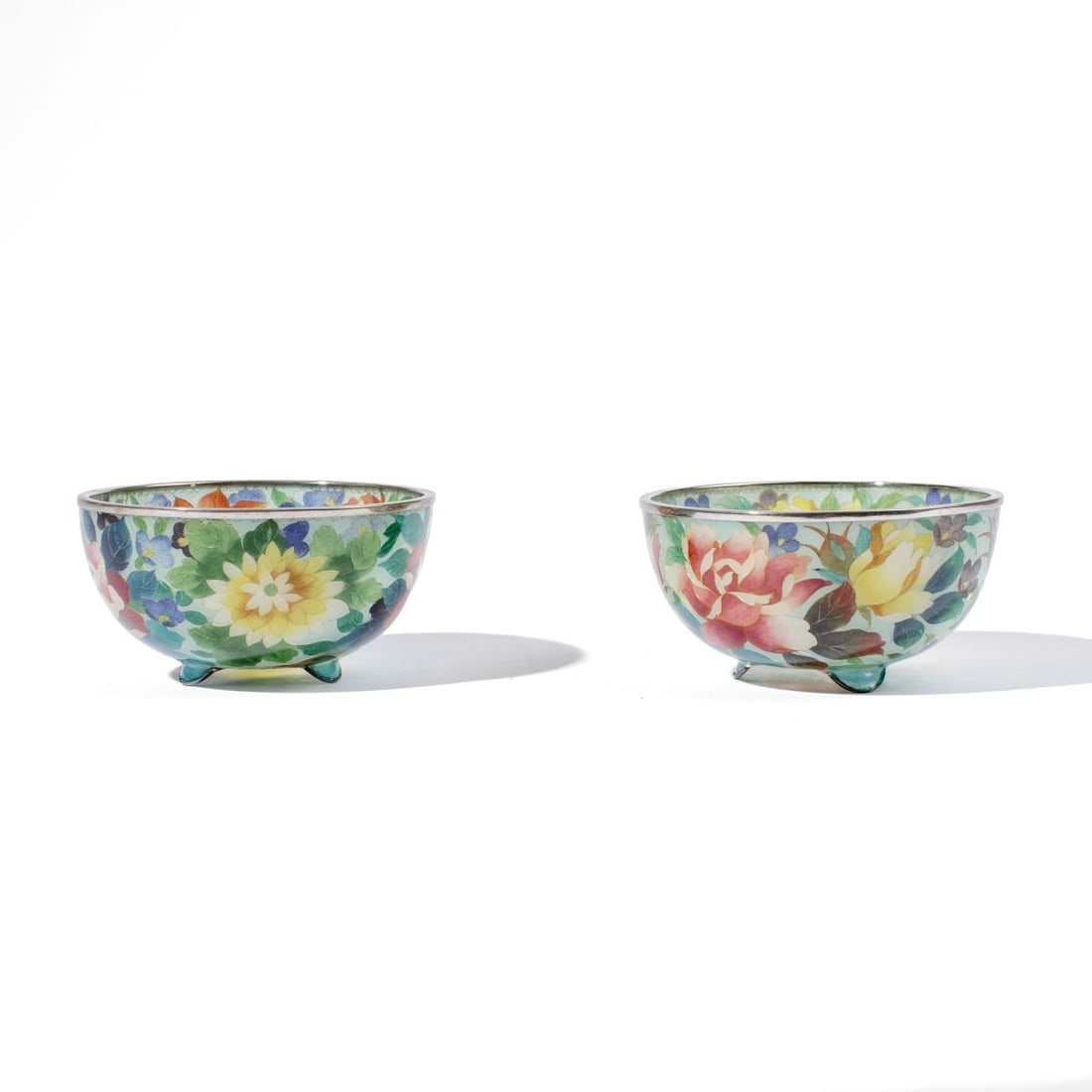 Japanese Plique A Jour Transparent Cloisonne Bowls: Pair early 20th century Japanese Plique A Jour silver wire transparent cloisonne bowls in similar floral designs on 3 raised feet. A similar bowl is in the collection of the Phoenix Art Museum. Excell