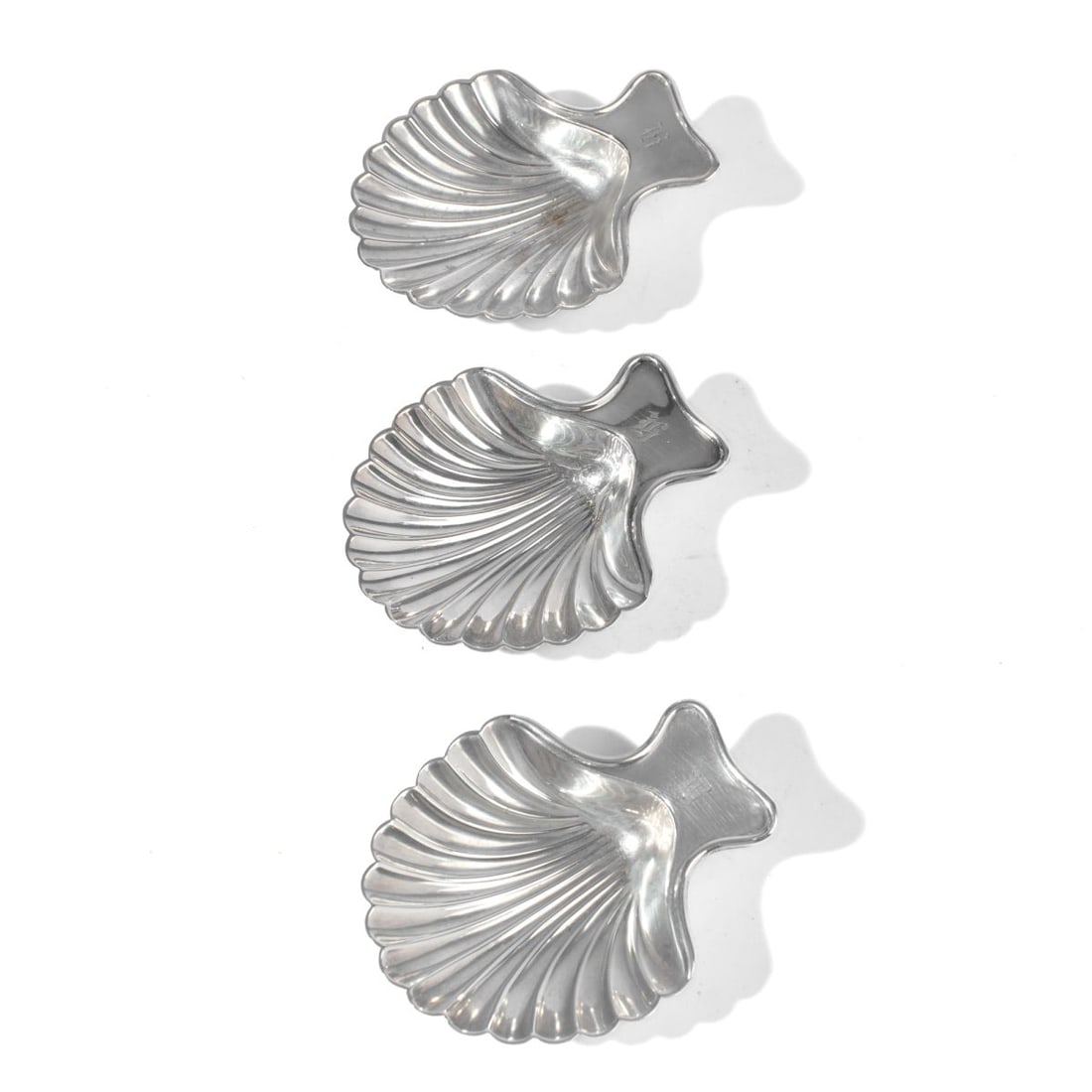 Tiffany & Co. Silver Soldered Scallop Shell Bowls: Set 3 vintage small Tiffany & Co. shell form silver plate bowls on raised shell feet. Engraved initials to handles. Marked: TIFFANY & Co SILVER SOLDERED 10 C along with S in diamond marks. Two in very