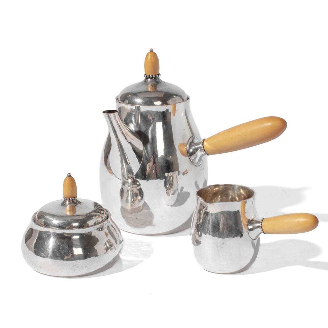 Georg Jensen Sterling Silver Coffee Service 80: Georg Jensen sterling silver 3-piece coffee set with turned boxwood handles. All hand hammered pieces marked with 1933-1944 Jensen logo mark, DENMARK, STERLING, 925.S; pot marked 80B and creamer /