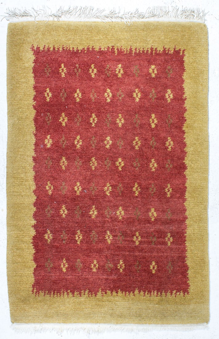 Tibetan Hand Knotted Wool Rug: Thick hand-knotted wool on cotton Tibetan rug. Red tone field with repeating designs in brown and gold. Border in golden tone. Different style fringe at each end. Very good condition. 4' 1" x 6' 6" (i