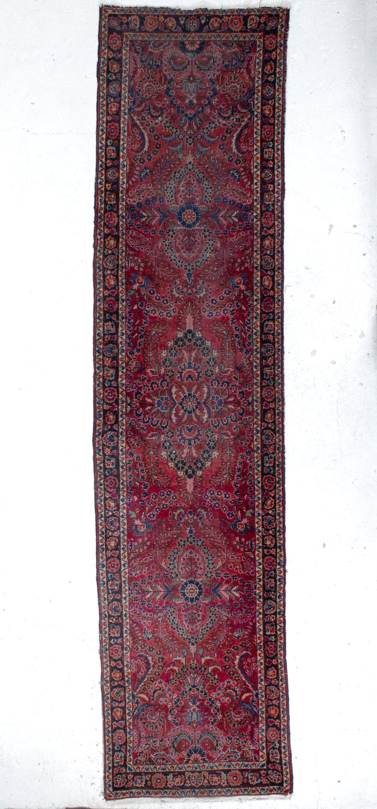 Vintage Persian Sarouk Runner Rug 11' 5": Vintage Persian Sarouk runner. Handknotted wool on cotton with intricate floral medallions on a mellow red field. Good aged condition with some areas of expected pile wear, edge fraying, etc. No appar