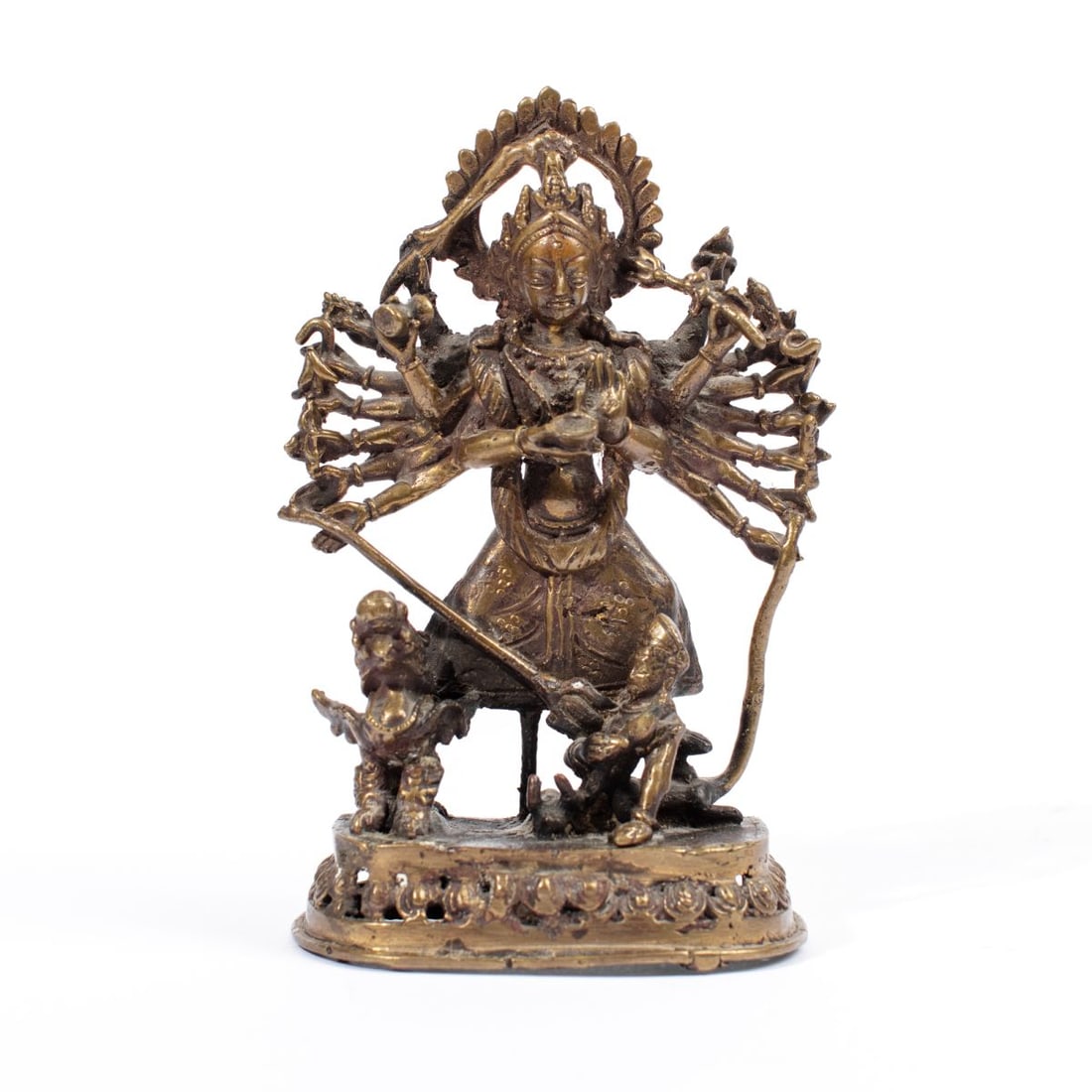 SE Asia Bronze Brass Hindu Goddess Durga Figure: SE Asian / Nepal bronze Brass Hindu goddess Durga figure in slayer of the buffalo demon pose. Multiple arms holding celestial weapons with her slaying the buffalo demon with the sacred lion to her rig