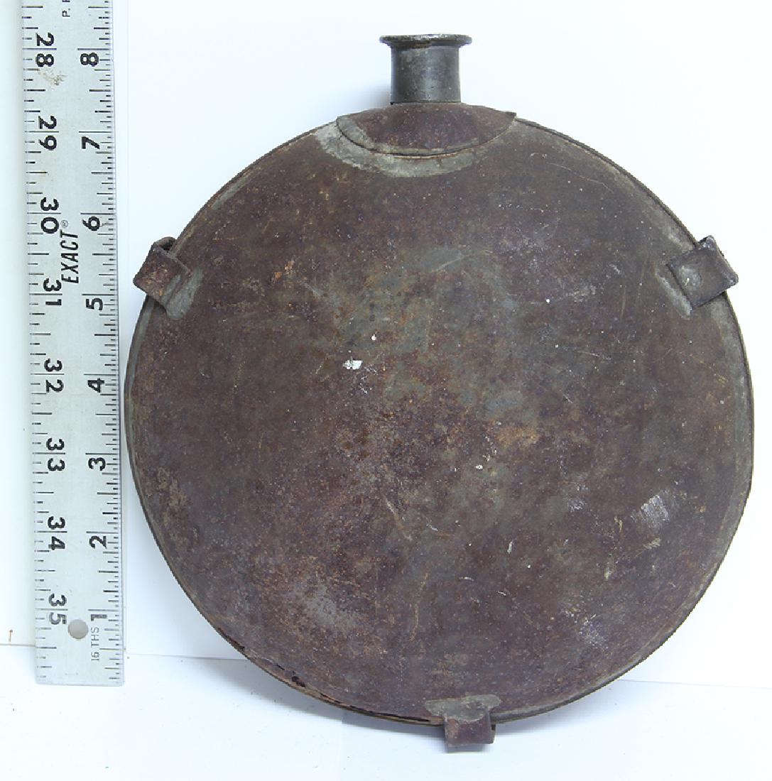 CIVIL WAR 1858 PATTERN CANTEEN: An early battlefield pickup canteen or a barn-find. Brackets and spout in place. Minor dents. Overall standing rust with some light traces of tinning. Rust holes along the bottom seam. Looks good in a