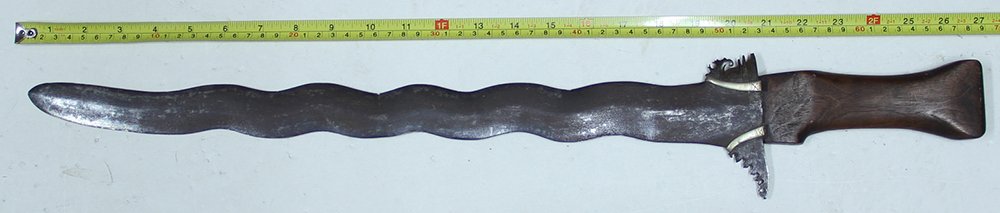FLAME BLADED MORO KRIS: From the Spanish American War era this is a relic of the Philippine Insurrection. The wide, flame-bladed kris is most closely associated with Moro fighters in the Philippines. U.S. forces clashed with