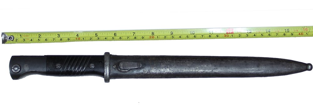WORLD WAR II GERMAN MAUSER K98 BAYONET AND SCABBARD: Grip is good with no chips or cracks, but small scratches behind rear screw on obverse. Hilt shows silver with darker gray spots on reverse; thin blue on obverse, with gray spot forward of button. Bla