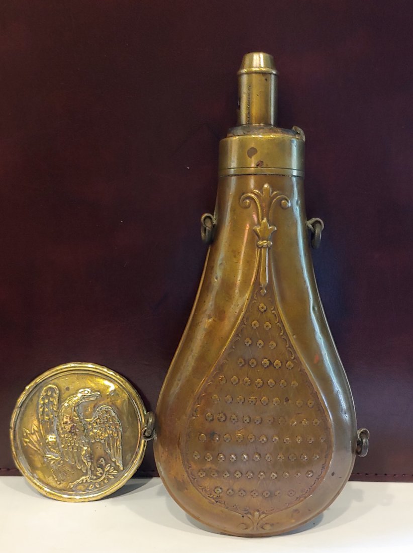 PRE CIVIL WAR GUNPOWDER FLASK: Very nice civilian powder flask with copper body and brass top. 8 inches tall. The flask is complete and functions perfectly. The raised designs include a teardrop shaped border with floral points top