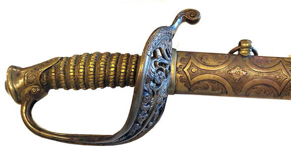 PRESENTATION GRADE CIVIL WAR SWORD: Outstanding example of a variant high grade foot officer's sword with elaborate foliate guard, brass mounted steel scabbard, and richly etched blade. While this sword looks like a Staff & Field patter