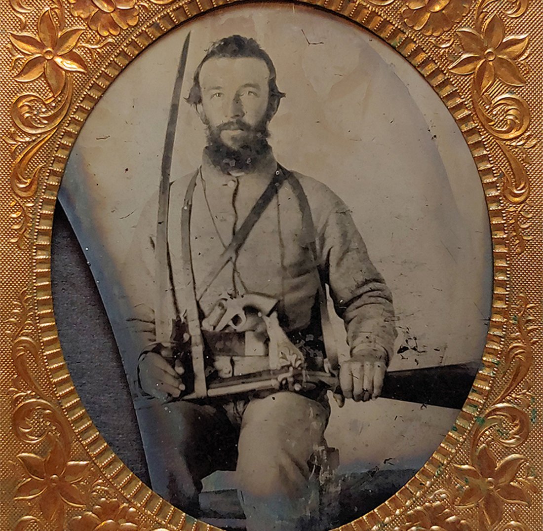 Civil War Armed Confederate 8th Tennessee Cavalry: Sixth plate ambrotype in case. This is as classic a Confederate cavalryman as anyone could hope to find, identified with a wonderful inscription inside the case. Our soldier has his CSA short jacket, 