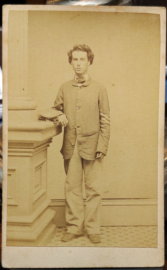 Identified Civil War CDV Photo Connecticut Soldier: This carte-de-visite by Thompson of Norwich, Ct., shows a soldier in a four-button fatigue blouse standing next to a column on the edge of which he has placed his forage cap. He wear the chevrons of a