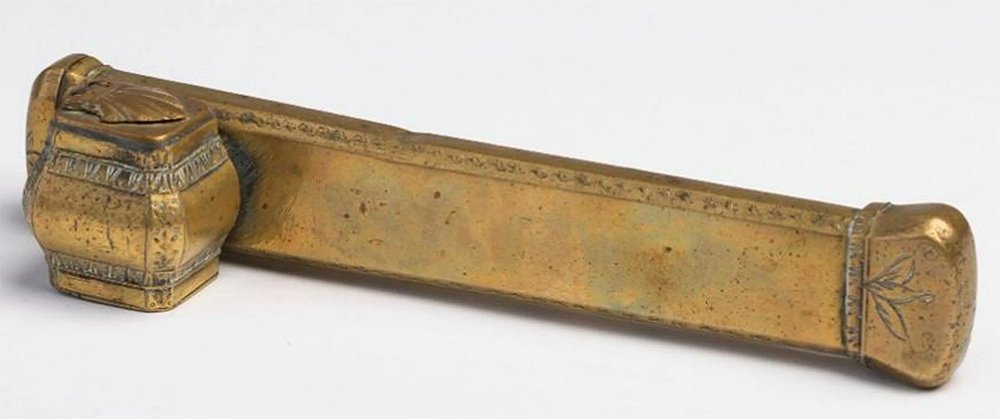 Persian or Turkish Brass Pen and Inkwell Case: A little over 8 inches long. Hand made in solid brass with simple peened brass pins acting as rivets on the hinges. Has hinged lid covering the area to hold pens, and another hinged lid over the ink w