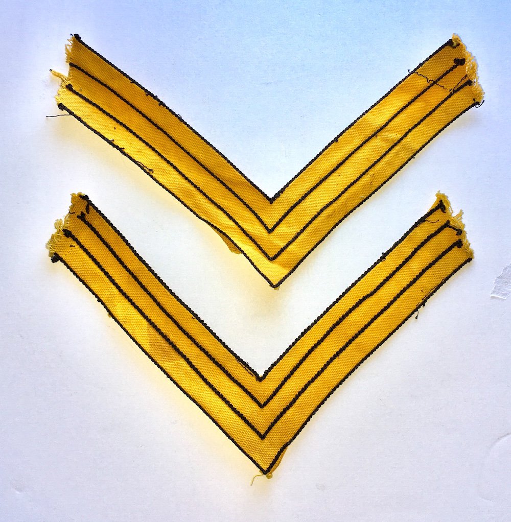 U.S. CAVALRY SERGEANT'S CHEVRONS: A nice original pair of chevrons for a U.S. cavalry sergeant. These are the 1872 pattern constructed of a solid color background to designate the branch of service with black chain-stitched border lin