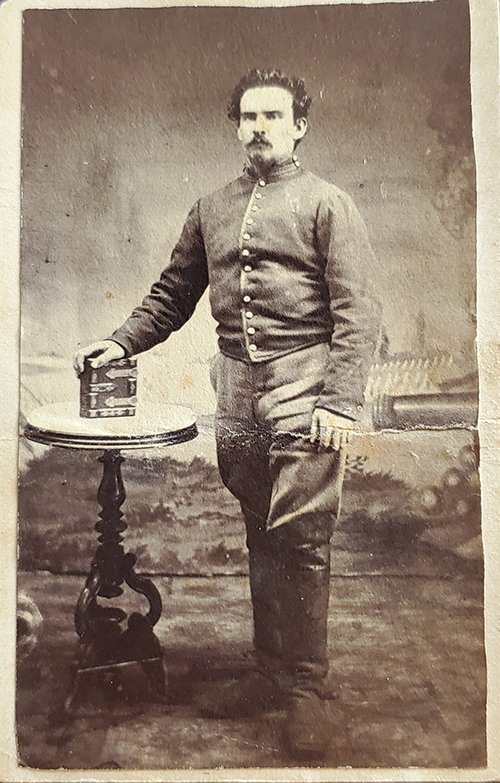 CIVIL WAR CDV OF AN ARTILLERYMAN OR CAVALRYMAN: -NO RESERVE-This carte-de-visite format photograph shows a young soldier wearing a mounted service jacket that indicates he is in the cavalry or artillery, though his nice high boots might point more 