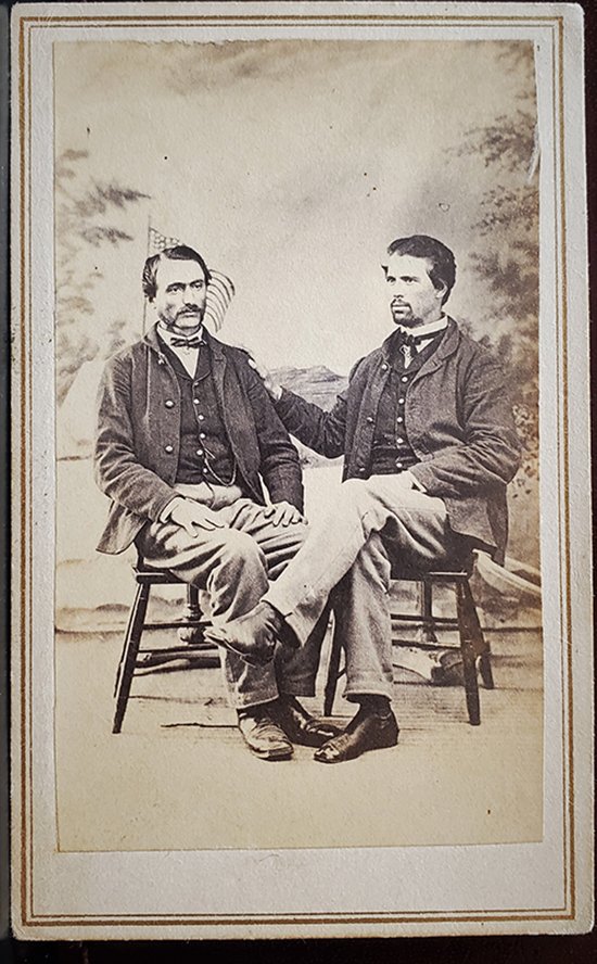 TWO SOLDIER PARDS, SYMPATHY AND DISCONSOLATION: -NO RESERVE-This nicely posed CDV by Pierce of Alexandria Heights, Va, shows two seated Federal soldiers in front of a painted backdrop showing a US flag flying at left in front of what seems to be a 