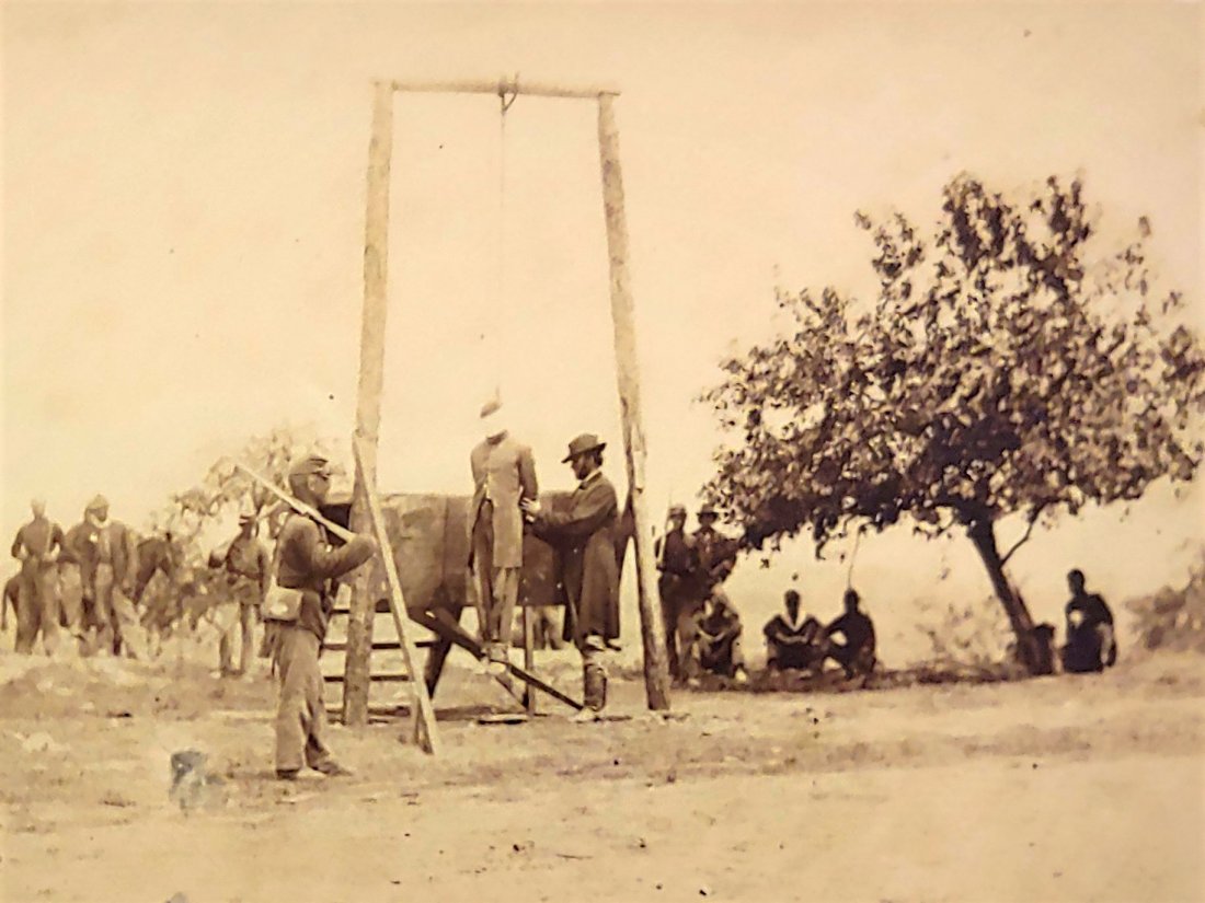 Stereoview Civil War Execution Black Soldier Lynching: Matthew Brady image. A fit and trim US Colored Troops Yankee infantryman in a regulation 9-button frock coat is blindfolded and hanging dead from the gallows. An officer is tending to the corpse as an