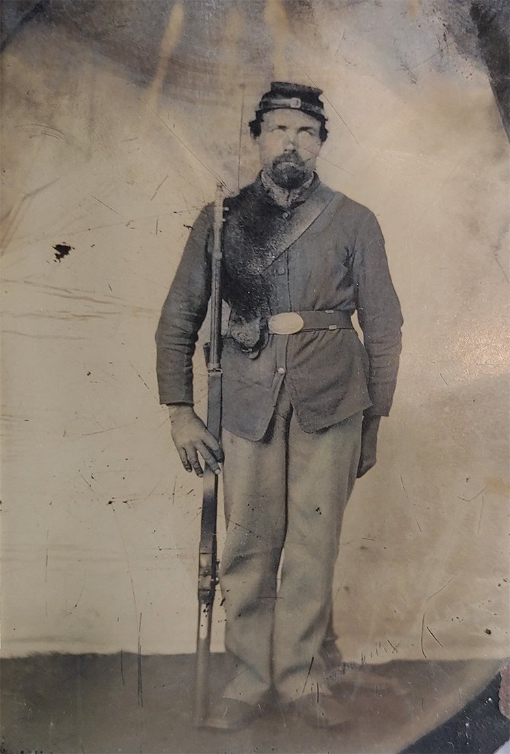 Civil War tintype Identified Armed Soldier: Eighth plate tintype 4 x 2.5 inches standing Union Army infantryman in fatigue uniform and holding his Model 1861 Springfield rifle musket. Back of tintype has ink note reading Martin Hildebrand soldi