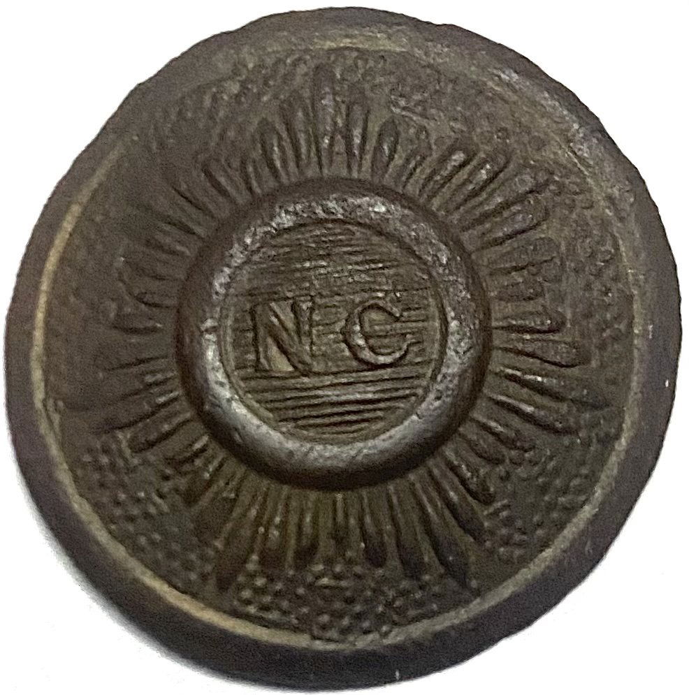 North Carolina Button Fisher's Hill: A solid blouse size North Carolina starburst button (NC-16) found in the 1960s with a metal detector at Fisher's Hill. Blank back no shank. From a 60 year collection I just obtained. Packing and shipp