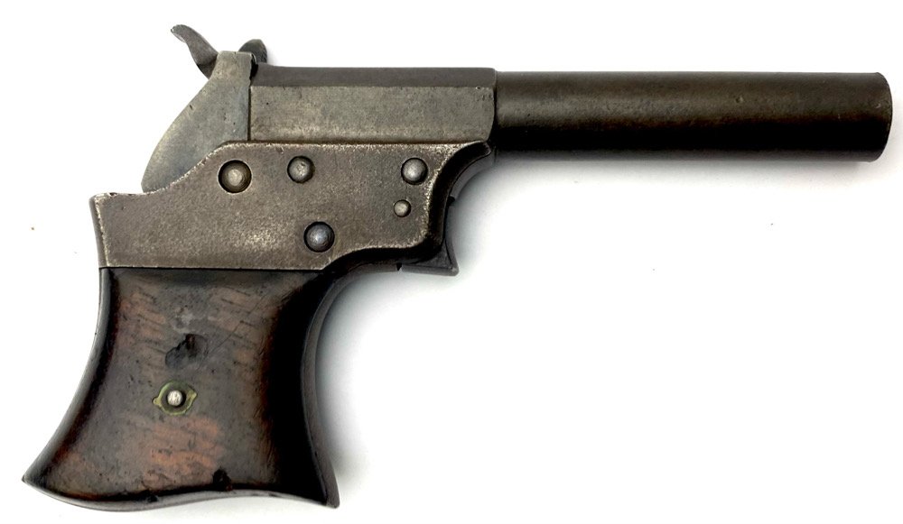 Remington Vest Pocket pistol: Manufactured from 1865 to 1888. The top barrel flat is stamped with the standard two line Remington address and patent dates. Matching serial number on the frame and barrel. Grips have worm damage. St