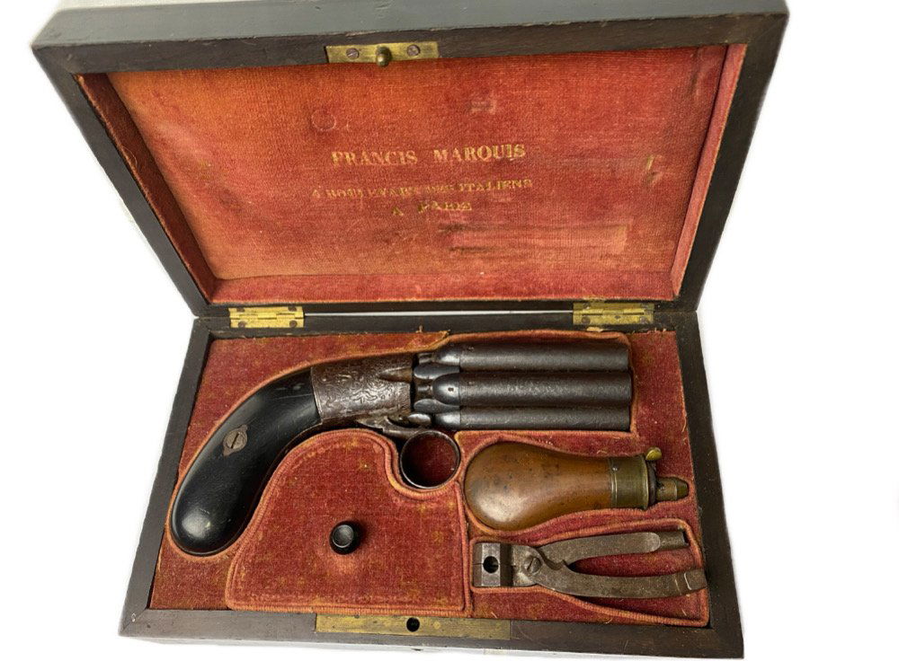 Cased Belgian Mariette 6 Barrel Pepperbox Pistol: Belgian Mariette Brevette Percussion Pepper Box 6-Shot .36 caliber Revolver housed in a fine French form fitted casing with wonderful dealer markings on the velvet in the lid. The original combination