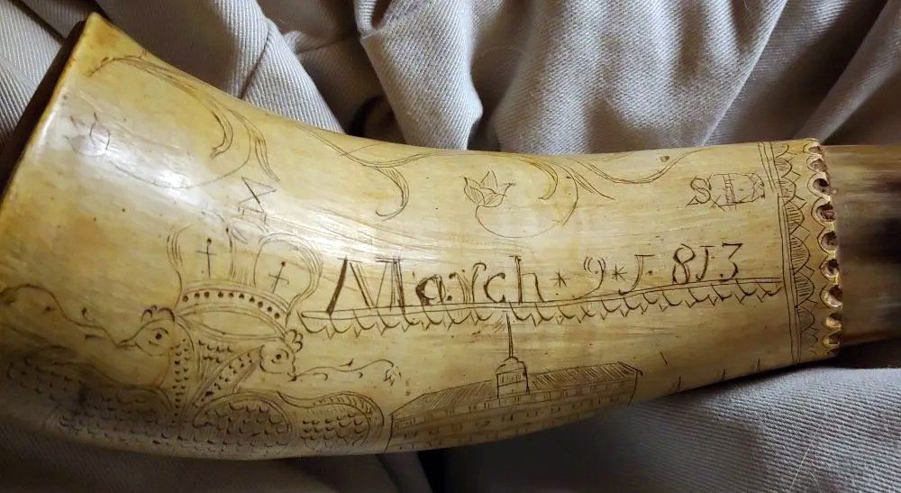 War of 1812 carved Powderhorn: This powder horn is nicely decorated and is dated March 9, 1813. It is decorated with Masonic and nautical motifs that include a mermaid, ocean waves, sailing ships, and an alligator. The two headed M