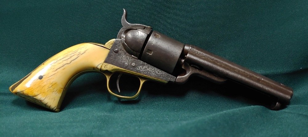 Ivory grip Factory engraved Colt Cowboy Conversion: About as appealing and honest a Wild West Colt six shooter as you could hope to find. Model 1851 Navy Revolver, factory engraved with factory Ivory grips. This was converted to 38 caliber metallic Rim