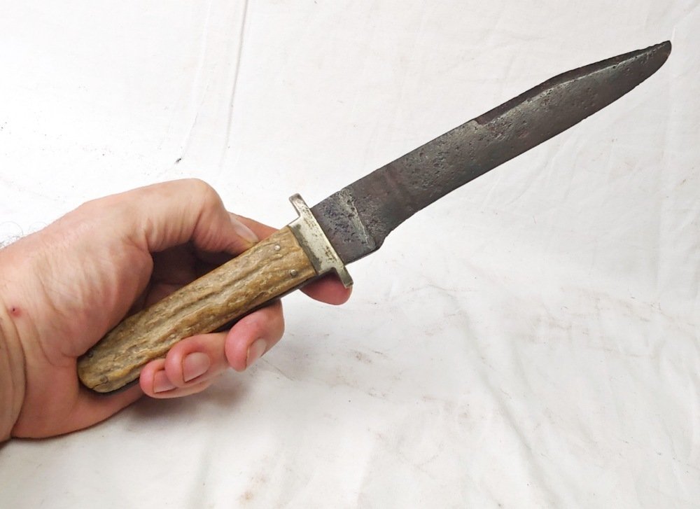 Large well used Bowie knife: Stag handled Bowie with German silver guard and clip point blade. Well used Bowie with pitting to the blade, stains to the guard and grips showing war and exposure to the elements. Short and stable cr