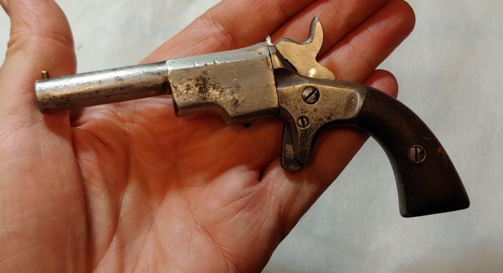 Civil War Single Shot Vest Pocket Pistol: Small caliber Rim fire 1860s single shot pistol. Very worn. Someone spent a lot of time repairing this little terror. The hammer and trigger are hand crafted 20th century restorations. The hammer spri