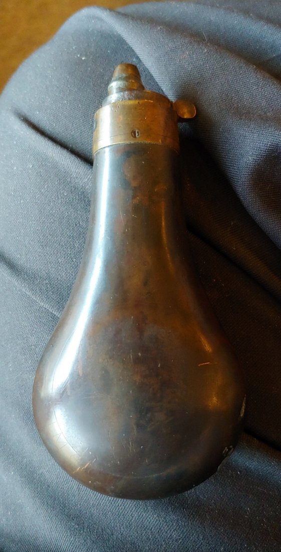 Really Pretty 1850s to 1860 Powder flask: 5 inches overall length. The copper body is beautiful with deep patina and no dents or scratches. Brass top, no seam openings, functions perfectly. Plain design so appropriate to display with any good