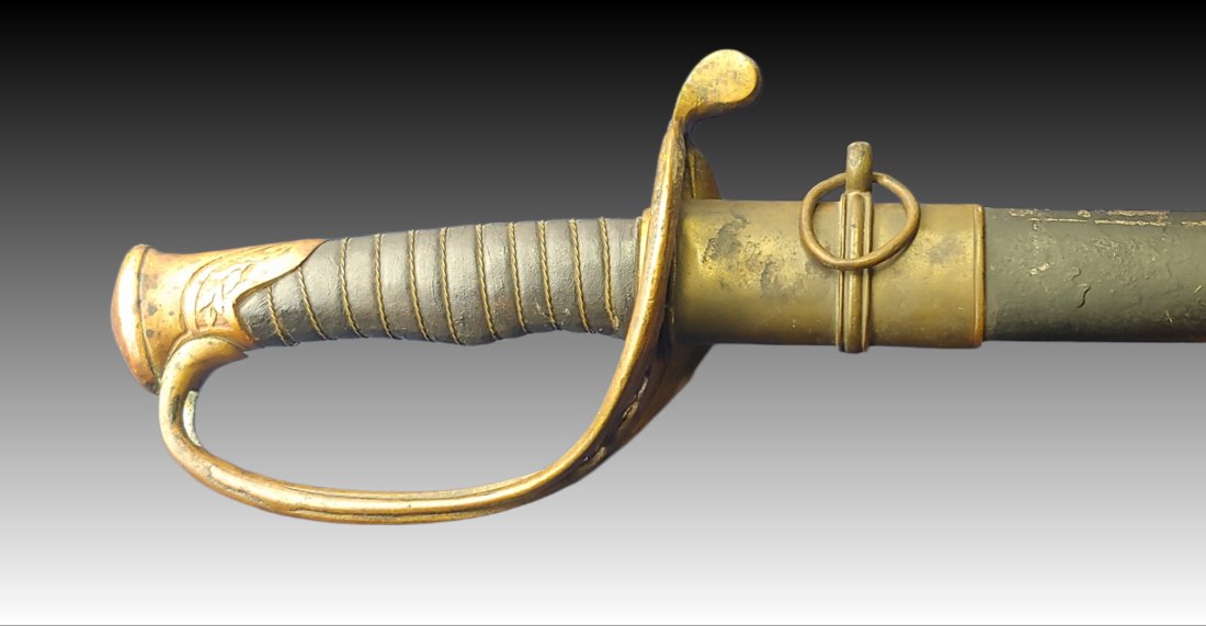 Boyle and Gamble Confederate Officer's Sword: Made in Richmond by Boyle and Gamble. Solid condition in a French scabbard missing the lower ring. Grip wrap is a restoration. Guard has a split from being severely bent and unbent. Fall from horse? A