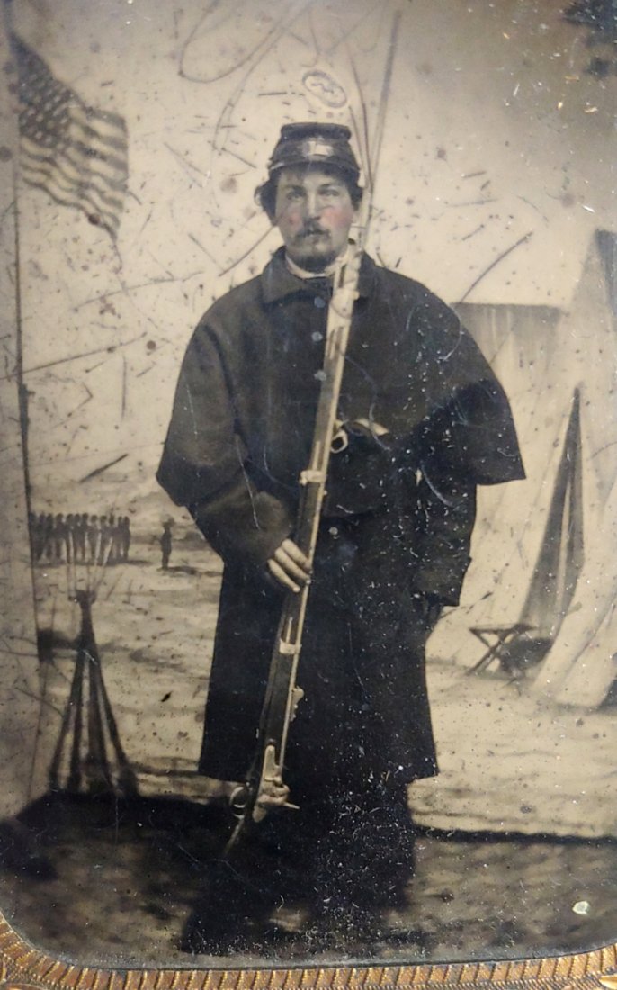 Civil War tintype armed and patriotic: Quarter plate tintype. Musket is clearly a rifled and sighted Remington Maynard tape conversion of a US 1816 musket. This had been tacked to a wall during the old days. Still good condition. Materials