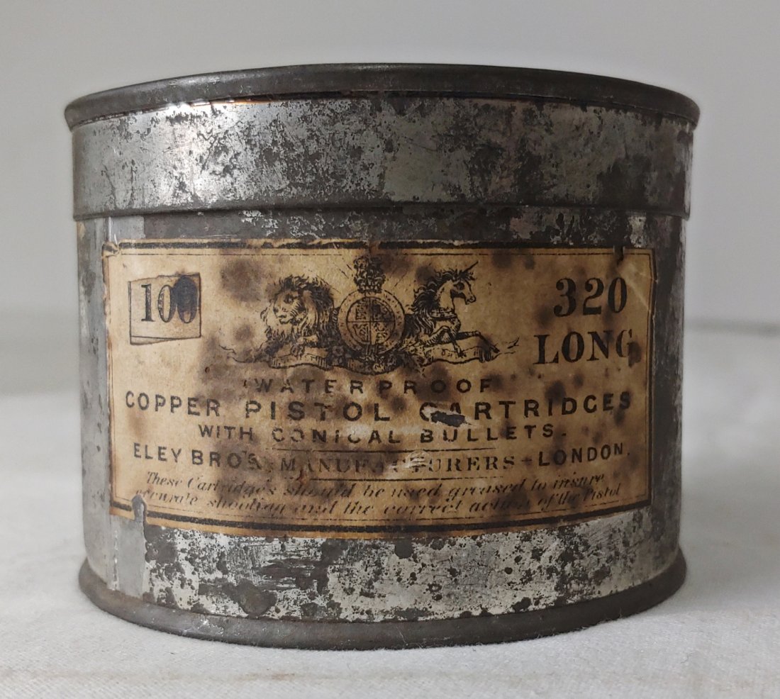 Original 1860s Ely Brothers container 32 Caliber Rimfire cartridges: A large original 1860s tin of 32 caliber rimfire cartridges carrying the original paper label from Eley Brothers in London. Excellent condition. Darn rare. Still contains 76 original 1860s cartridges 