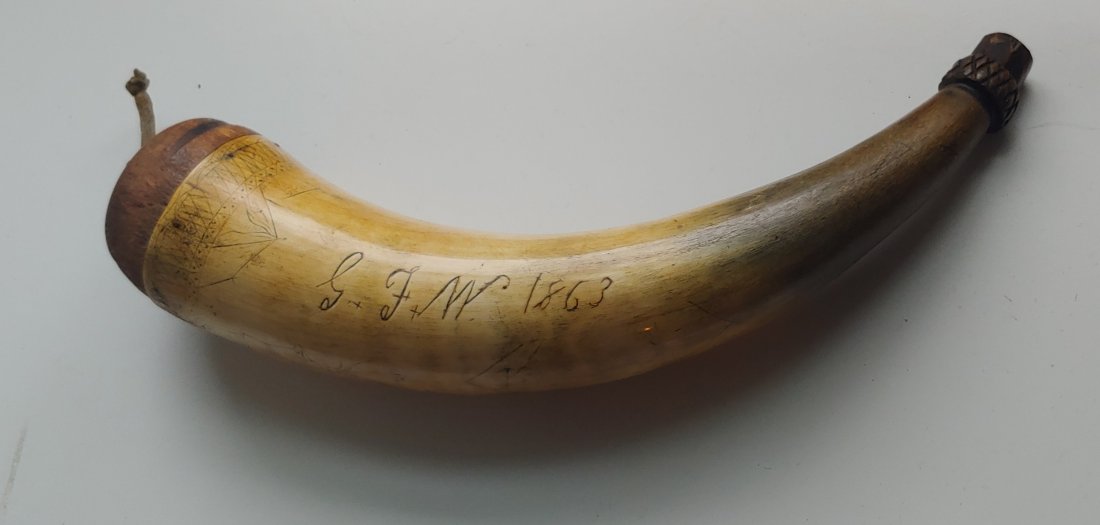 Genuine western frontier Indian Fighters Powderhorn: Dead real and very handsome. The scrimshaw is trying to tell a story but I'm not quite able to make out what it is saying. The main artwork is the owners initials GFW and date of 1863 and a standing a